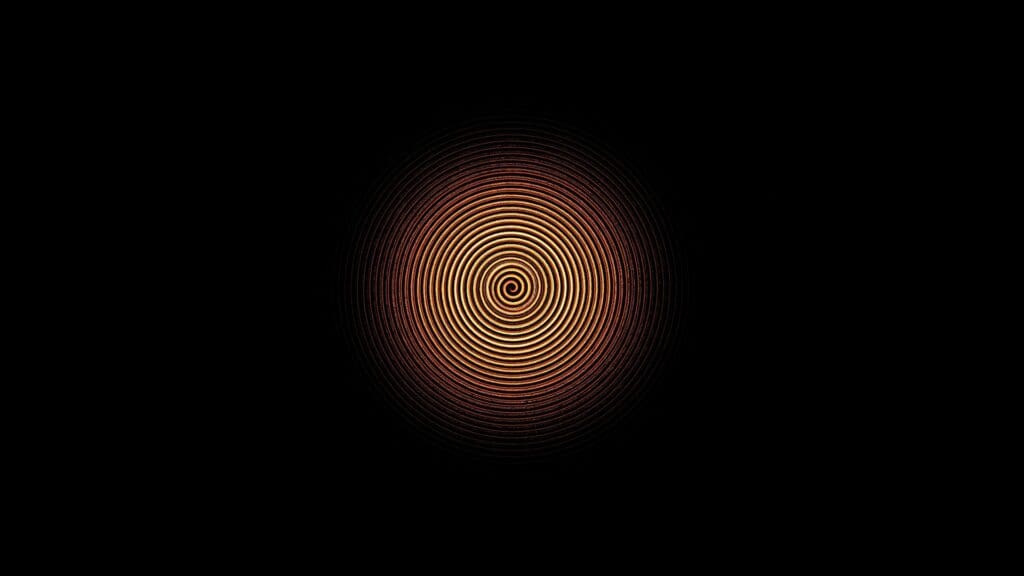 Goldene Spirale auf schwarzem Hintergrund.